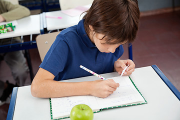 Image showing Schoolboy Copying From Cheat Sheet During Examination