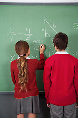 Image showing Teenage Students Solving Mathematics On Board