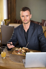 Image showing Business man With Mobile phone And Laptop