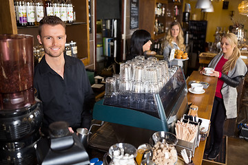 Image showing Male Bartender With Colleague Working In Background