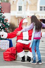 Image showing Girl About To Embrace Santa Claus