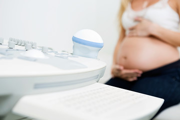Image showing Ultrasound Machine With Pregnant Woman In Background