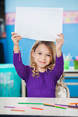 Image showing Girl Showing Blank Paper At Desk