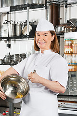 Image showing Happy Chef Mixing Egg With Wire Whisk In Bowl