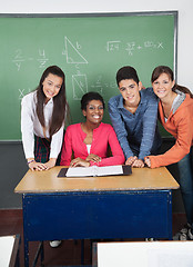 Image showing Teacher With Teenage Students At Desk In Classroom