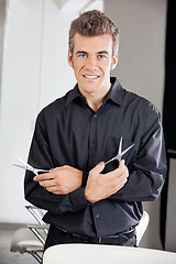 Image showing Confident Hairstylist Holding Two Scissors