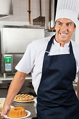 Image showing Male Chef Holding Baked Cake In Kitchen