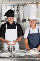 Image showing Chefs Kneading Dough In Kitchen