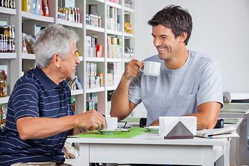 Image showing Father And Son Communicating While Having Coffee