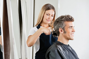 Image showing Female Hairdresser Cutting Client's Hair