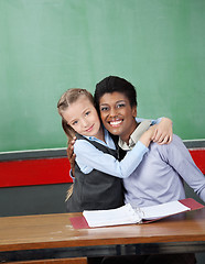 Image showing Schoolgirl Hugging Professor At Desk