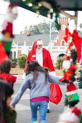Image showing Children Running To Embrace Santa Claus