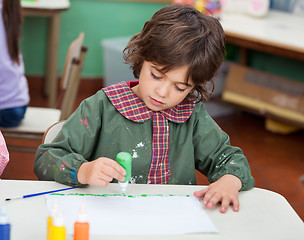 Image showing Little Boy Drawing In Art Class