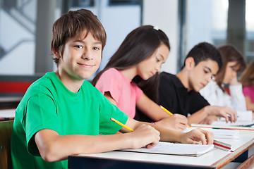 Image showing Teenage Boy With Friends Studying At Desk