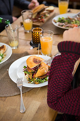 Image showing Young Woman With Burger In Plate