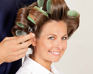 Image showing Client With Hairdresser Rolling Her Hair