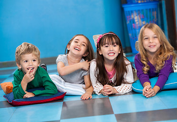 Image showing Children Lying In A Row On Floor In Kindergarten