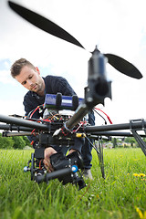 Image showing Technician Fixing Camera On Spy Drone