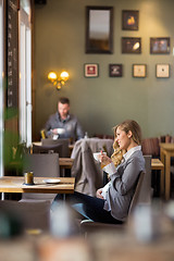 Image showing Pregnant Woman Having Coffee While Looking Away