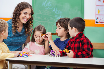 Image showing Teacher With Children Playing Musical Instruments