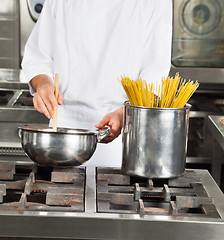 Image showing Male Chef Cooking Food In Kitchen