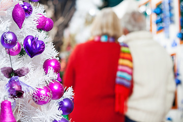 Image showing Decorated Christmas Tree And Couple In Store