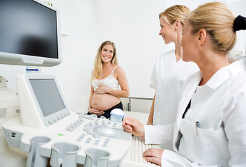 Image showing Gynecologists Looking At Pregnant Woman