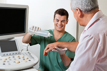 Image showing Technician Putting Gel On Patient's Hand