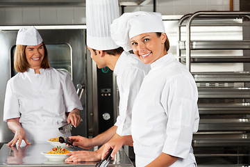 Image showing Female Chef With Colleagues In Commercial Kitchen