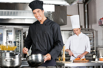 Image showing Chefs Cooking Food In Kitchen