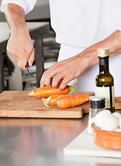 Image showing Male Chef Cutting Carrots