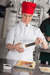 Image showing Female Chef Preparing Chocolate Roll