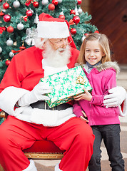 Image showing Girl Taking Present From Santa Claus