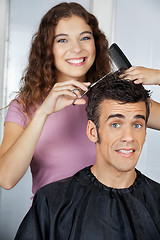 Image showing Happy Hairdresser Cutting Client's Hair At Salon