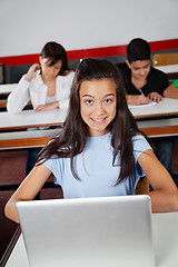 Image showing Teenage Schoolgirl Sitting With Laptop At Desk