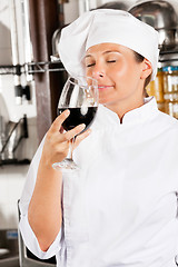 Image showing Female Chef Smelling Red Wine