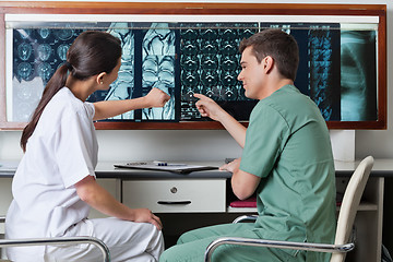 Image showing Medical Technicians Pointing At MRI X-ray