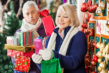 Image showing Happy Woman Shopping Presents With Tired Man