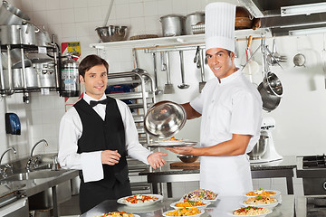 Image showing Waiter Taking Customer's Food From Chef