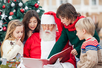 Image showing Santa Claus And Children Reading Book