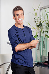 Image showing Male Hairstylist Standing With Arms Crossed In Salon