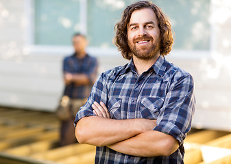 Image showing Carpenter With Arms Crossed Standing At Construction Site