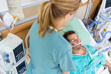 Image showing Nurse Adjusting Patient's Pillow