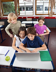 Image showing Schoolchildren Using Laptop At Desk In Classroom