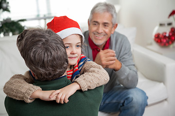 Image showing Son In Santa Hat Embracing Father