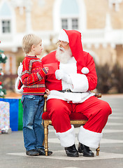 Image showing Boy Giving Wish List To Santa Claus