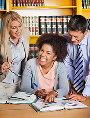 Image showing Cheerful Student With Teachers Standing Besides Her In Library