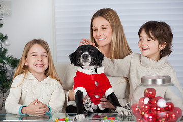 Image showing Family With Pet Dog At Home During Christmas