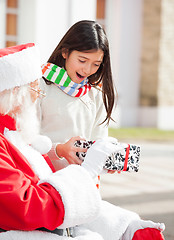Image showing Surprised Girl Taking Gift From Santa Claus