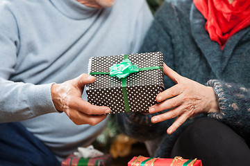 Image showing Couple Holding Christmas Present At Store